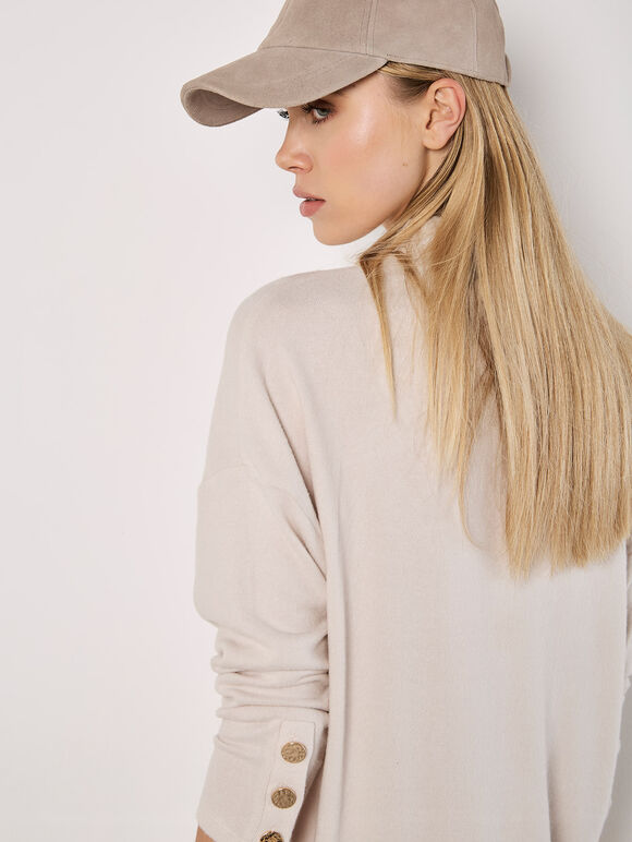A soft-milky white, tubular-shaped mini knitted dress